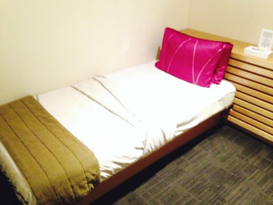 While not the Singapore Airlines - Private Room, the Malaysian Airlines First Class Lounge has Sleeperette Rooms where you can crash in between flights. SQ, take note!